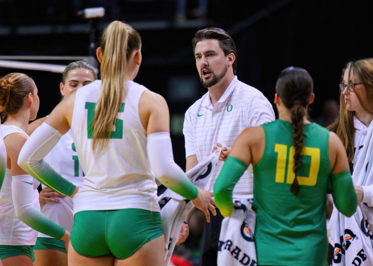 Head Coach Matt Ulmer speaks to his players during a time out. The University of Oregon Ducks Volleyball team defeated the University of Utah Utes in a home match at Matthew Knight Arena in Eugene, Ore., on Nov. 3, 2023. (Eric Becker/Emerald)