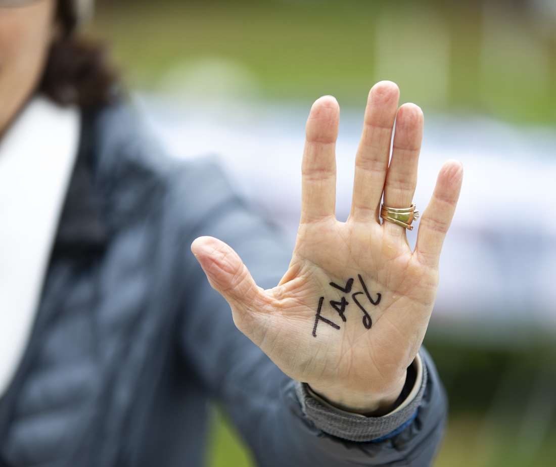 Lynn Jackson, a community member who attended the demonstration, holds up the name "Tal"&#8212;one of the 240+ Israeli captives held by Hamas&#8212;on her hand. She said she writes it so that every time she uses her hands, she is keeping the captives in her thoughts. (Alex Hernandez/Emerald)