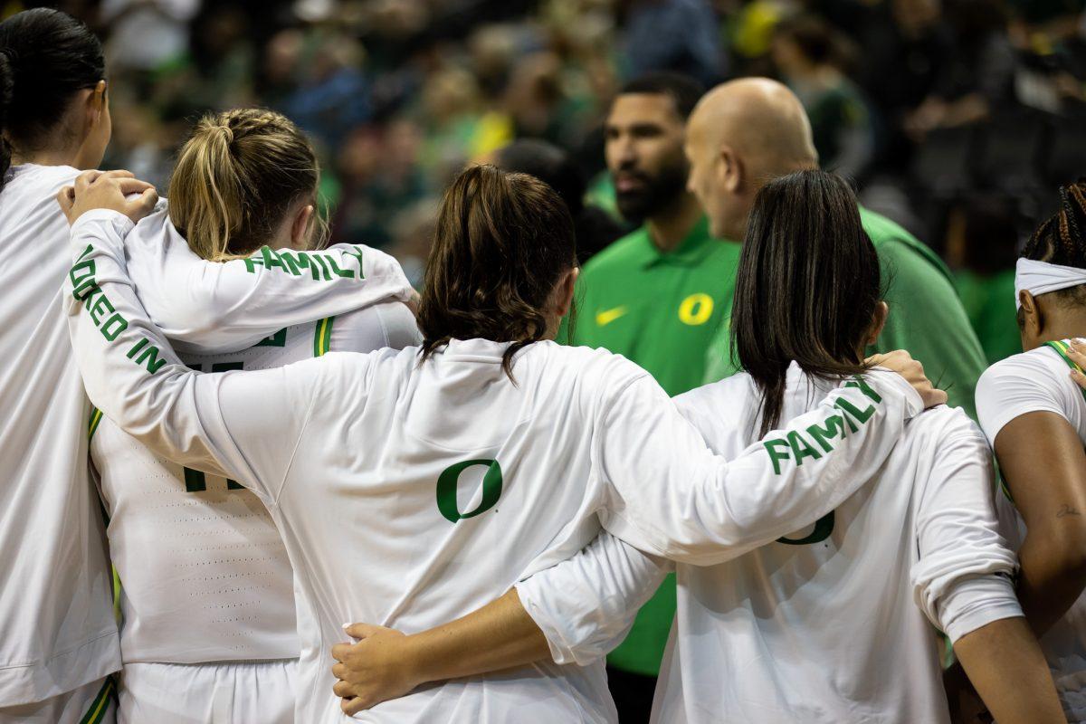 The team joins in arms during warmups to listen to coach Kelly Graves.&#160;The Oregon&#160;Women's&#160;Basketball team host Northern Arizona for their season opener &#160;at Matthew Knight Arena in Eugene, Ore., on Nov. 6, 2023. (Jonathan Suni, Emerald)