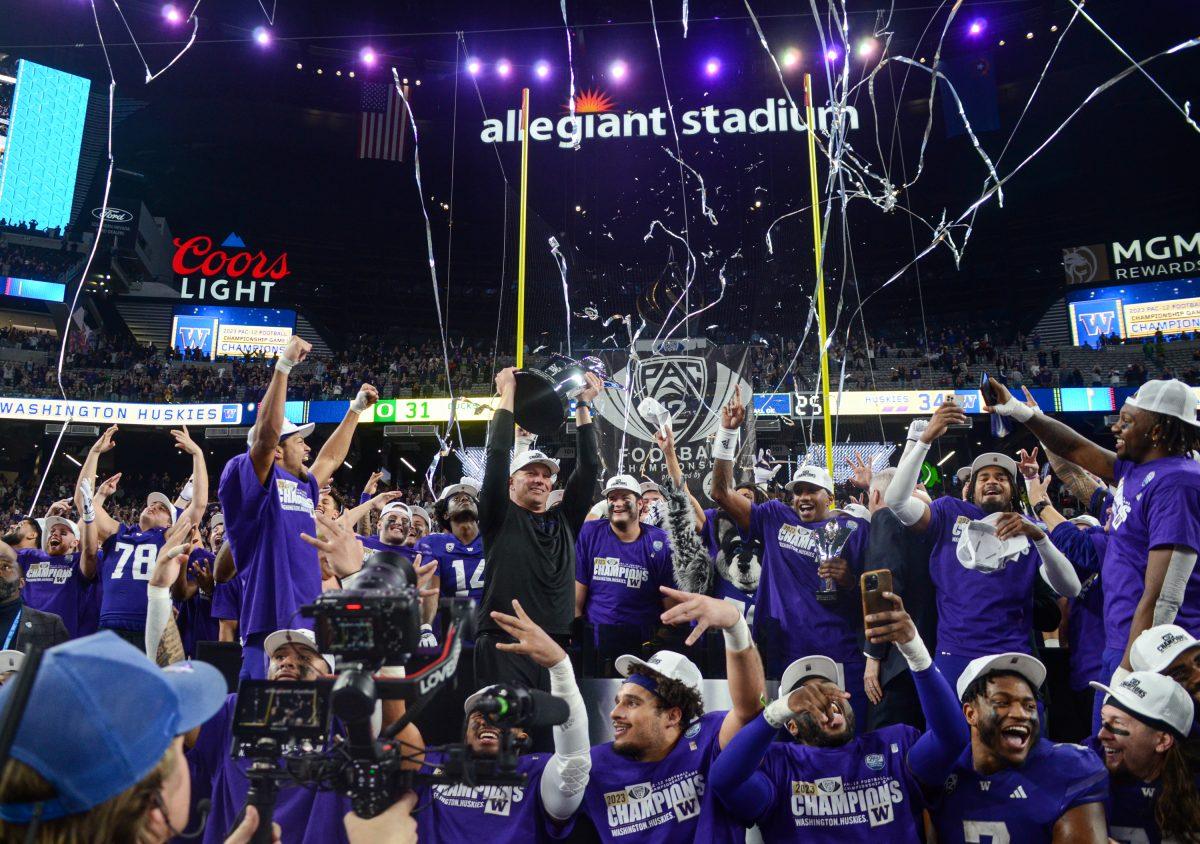 Washington head coach Kalen DeBoer lifts the last ever Pac-12 Championship trophy. The Washington Huskies defeat the Oregon Ducks football team in the Pac-12 Championship at Allegiant Stadium in Las Vegas on Dec. 1, 2023. (Kai Kanzer/Emerald)