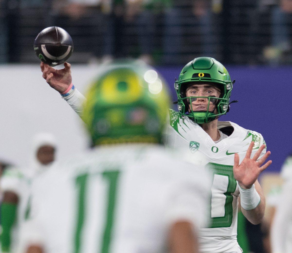 Bo Nix (10) completes a pass to his favorite target, Troy Franklin (11). The Washington Huskies defeat the Oregon Ducks football team in the Pac-12 Championship at Allegiant Stadium in Las Vegas on Dec. 1, 2023. (Kai Kanzer/Emerald)