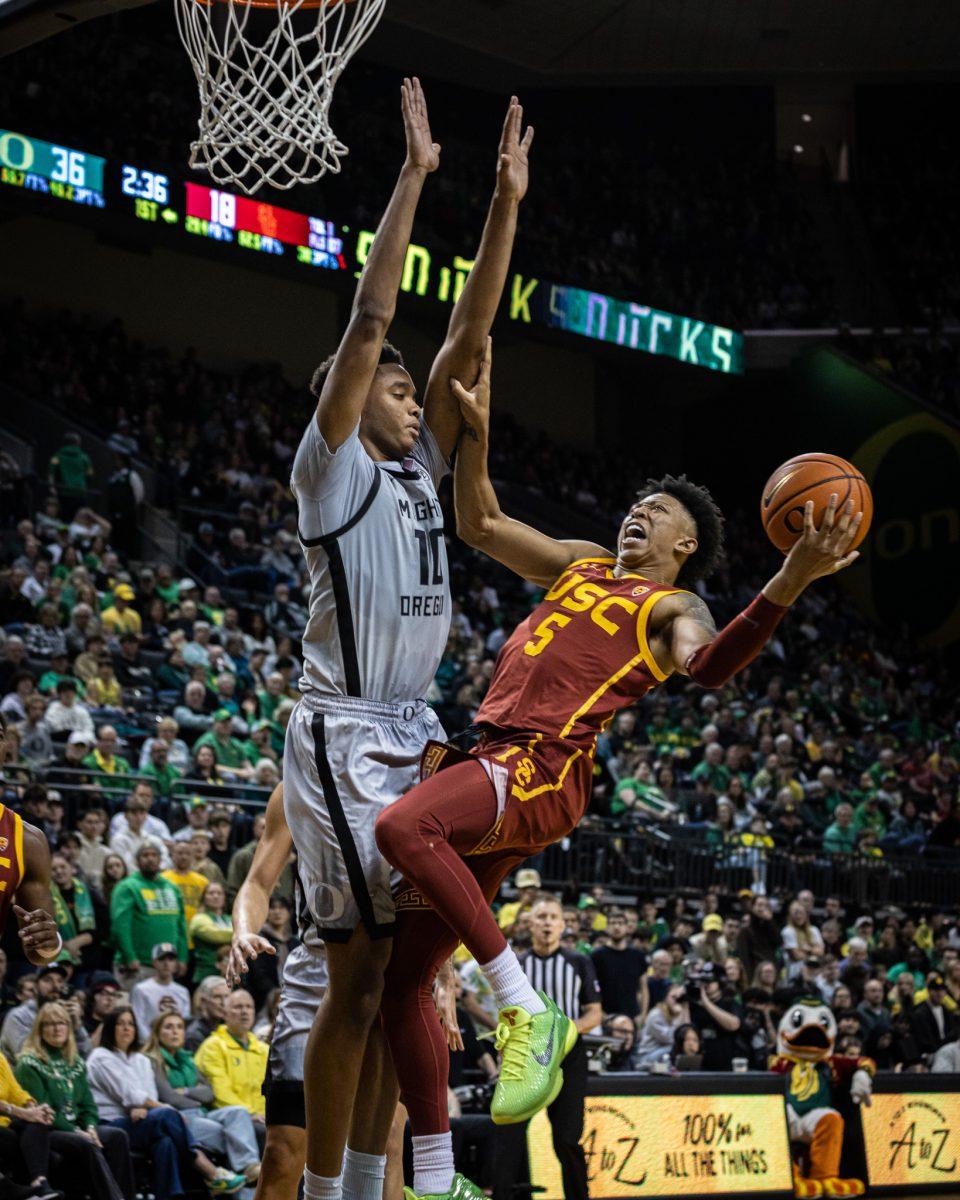 Fifth year USC star, Boogie Ellis (5), looks to draw a foul on Oregon freshman (KJ Evans (10).&#160;The Oregon Men's Basketball Team host the USC Trojans to start their last season of conference play in the PAC-12 &#160;at Matthew Knight Arena in Eugene, Ore., on Dec. 28, 2023. (Jonathan Suni/Emerald)