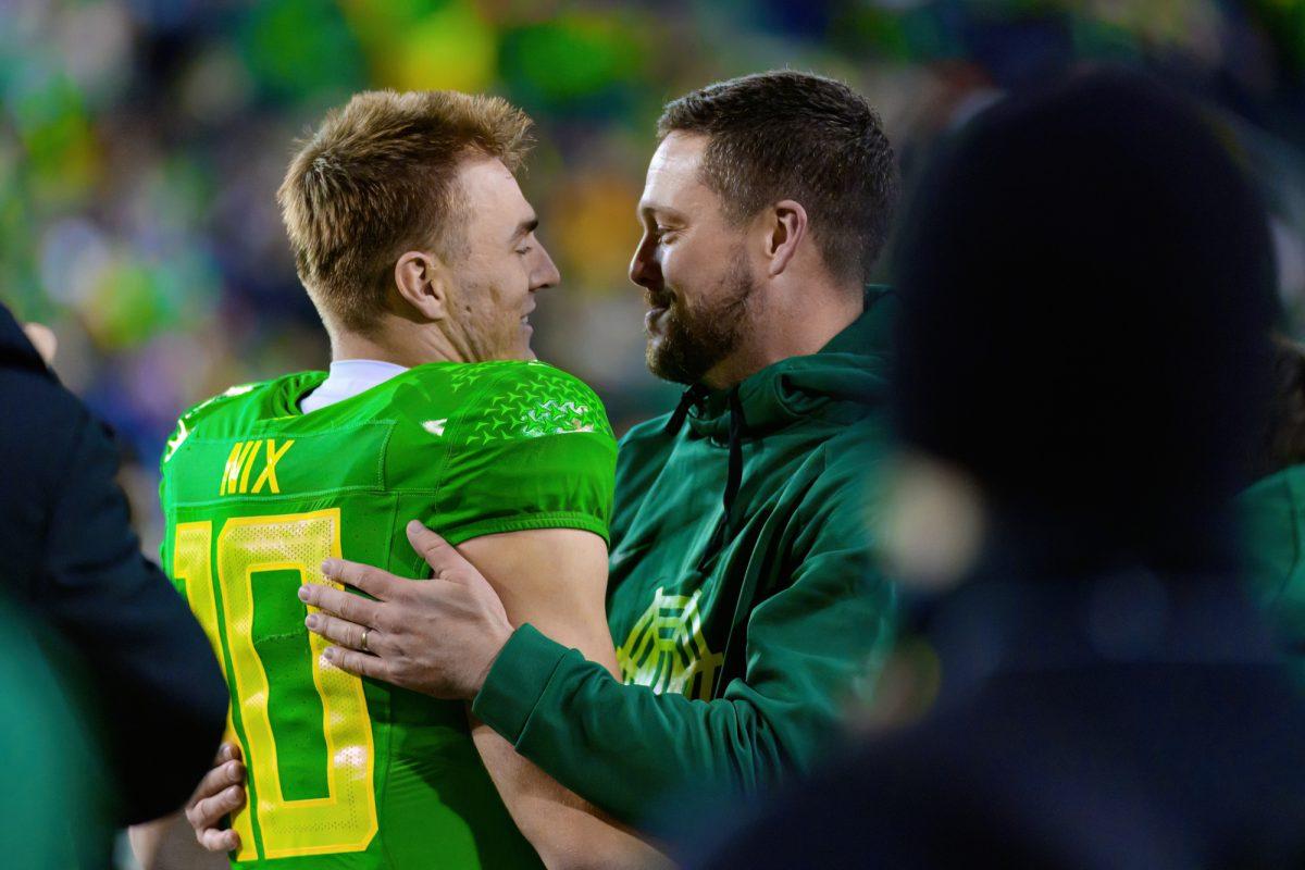 Oregon Head Coach Dan Lanning greets QB Bo Nix (10) during senior night celebrations. The University of Oregon Ducks Football team defeated Oregon State University 31-7 in a home match at Autzen Stadium in Eugene, Ore., on Nov. 24, 2023. (Eric Becker/Emerald)