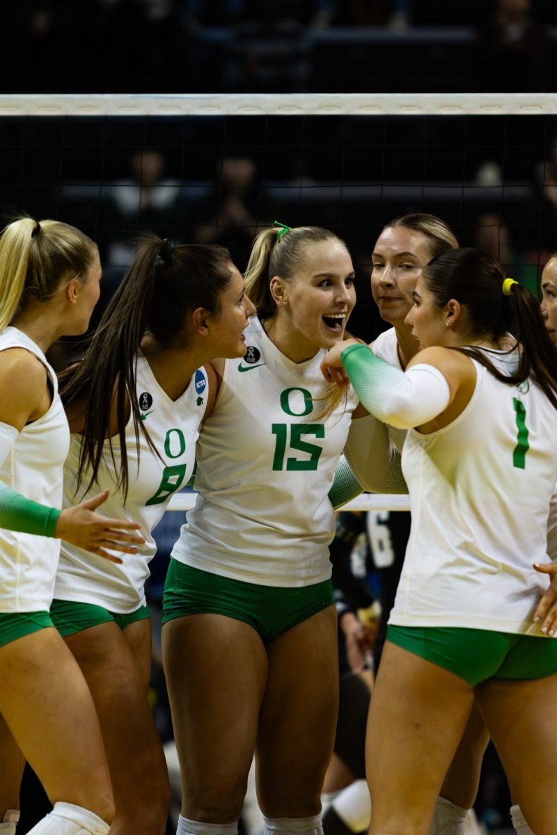 The Oregon Ducks Volleyball team celebrates as a group after gaining a crucial point during a key moment in the game. The University of Oregon Ducks Volleyball team defeated the Hawai&#8217;i Rainbow Wahine 3-0 in the second round of the 2023 Division I Women&#8217;s Volleyball Championship at Matthew Knight Arena in Eugene, Ore., on Dec. 1, 2023. (Sebastian Flores/Emerald)