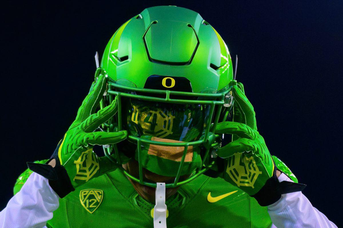 <p>Gloves honoring former Oregon TE Spencer Webb were part of the special uniform worn by Oregon. The University of Oregon Ducks Football team defeated Oregon State University 31-7 in a home match at Autzen Stadium in Eugene, Ore., on Nov. 24, 2023. (Eric Becker/Emerald)</p>