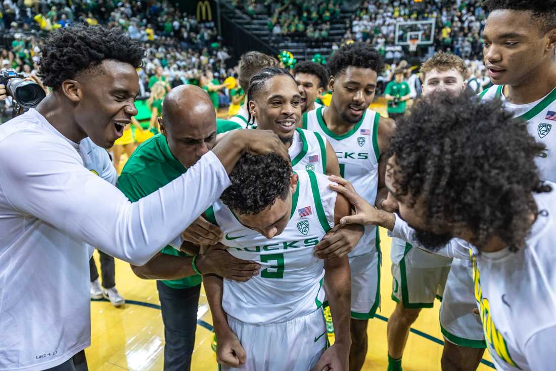 The Ducks celebrate with Jackson Shelstad (3) after he makes the game-winning shot. The Oregon Ducks men&#8217;s basketball team takes on the Michigan Wolverines on Dec. 2, 2023 in Eugene, Ore. (Molly McPherson/Emerald)