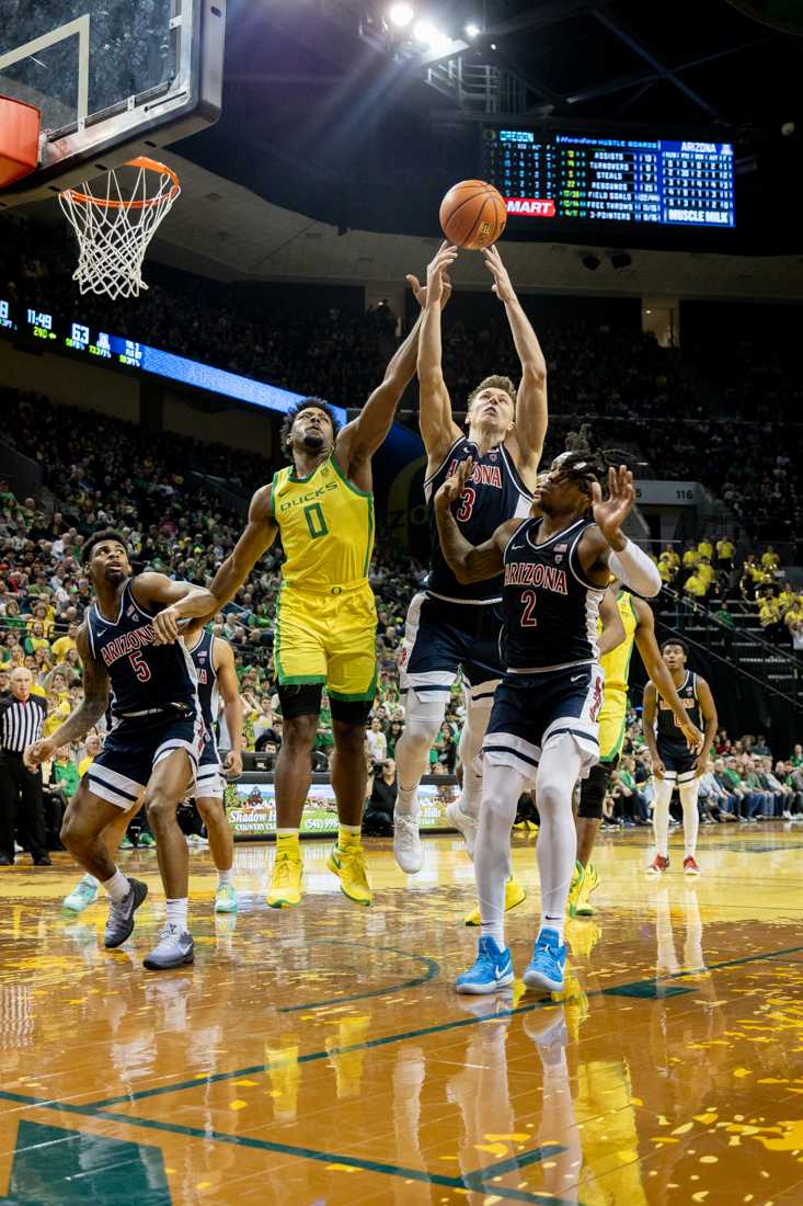 Kario Oquendo (0) fights for the offensive rebound against two Wildcat players. The University of Oregon Men&#8217;s Basketball team lost to the University of Arizona Wildcats 87-78 at Matthew Knight Arena in Eugene, Ore., on Jan. 27, 2024. (Kemper Flood/ Emerald)