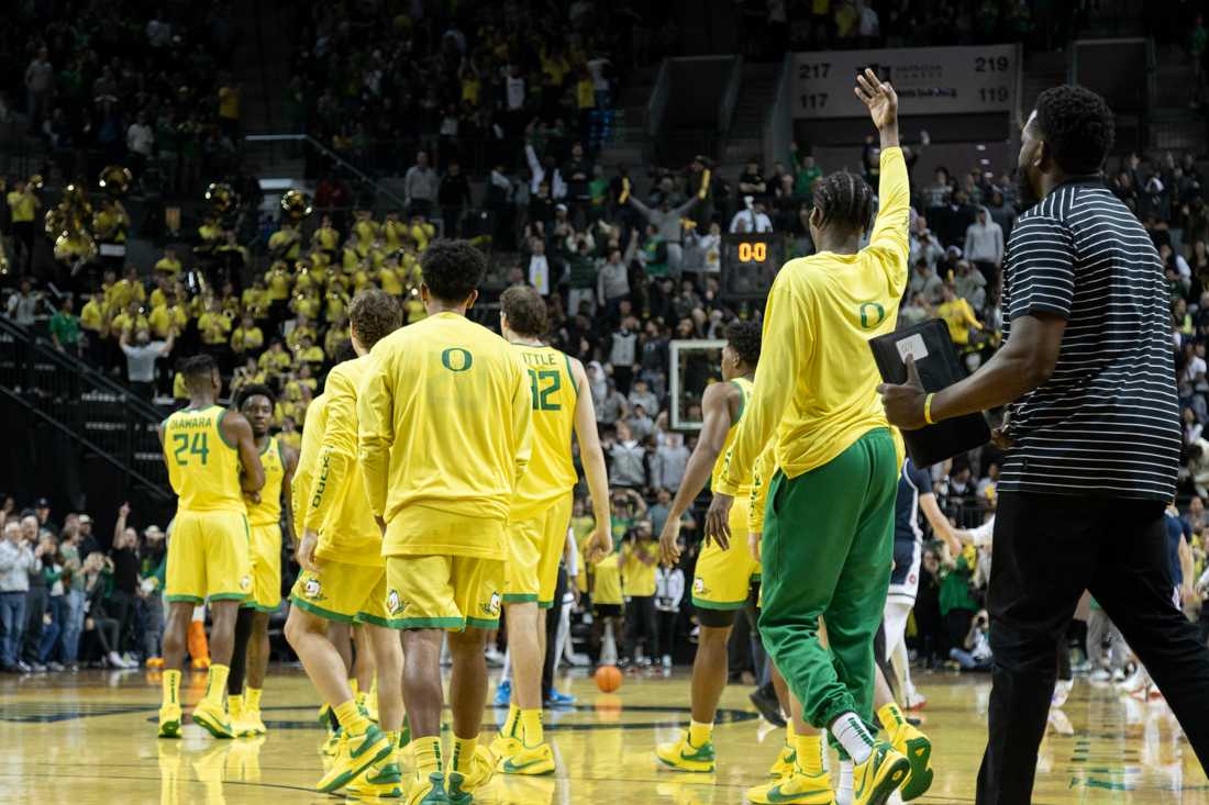 The Ducks bench runs onto the court after Jermaine Couisnard (5) makes a 3/4 court shot at the halftime buzzer. The University of Oregon Men&#8217;s Basketball team lost to the University of Arizona Wildcats 87-78 at Matthew Knight Arena in Eugene, Ore., on Jan. 27, 2024. (Kemper Flood/ Emerald)