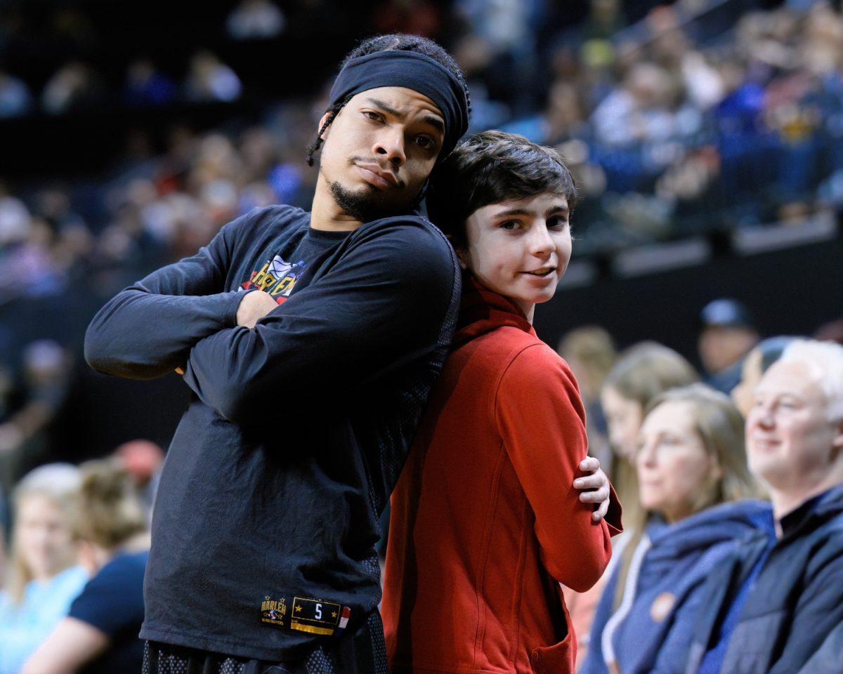 Globetrotters Guard "Wham" Middleton poses with a fan before the game. The Harlem Globetrotters defeated the Washington Generals in an exhibition match at Matthew Knight Arena in Eugene, Ore., on Jan. 19, 2024. (Eric Becker/Emerald)