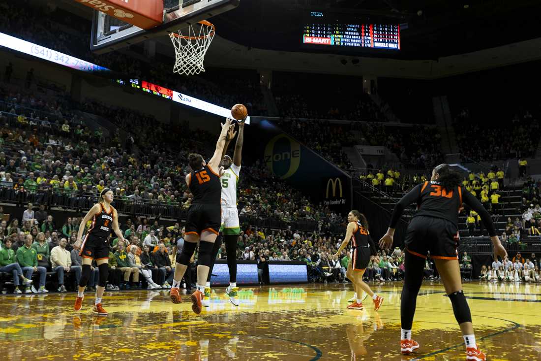 Oregon center Phillipina Kyei goes for a layup against Raegan Beers (15), Beavers forward. After a close second half, the Ducks lost their rivalry matchup 64-60 to the Beavers in Matthew Knight Arena on Feb. 4, 2024. (Alex Hernandez/Emerald)