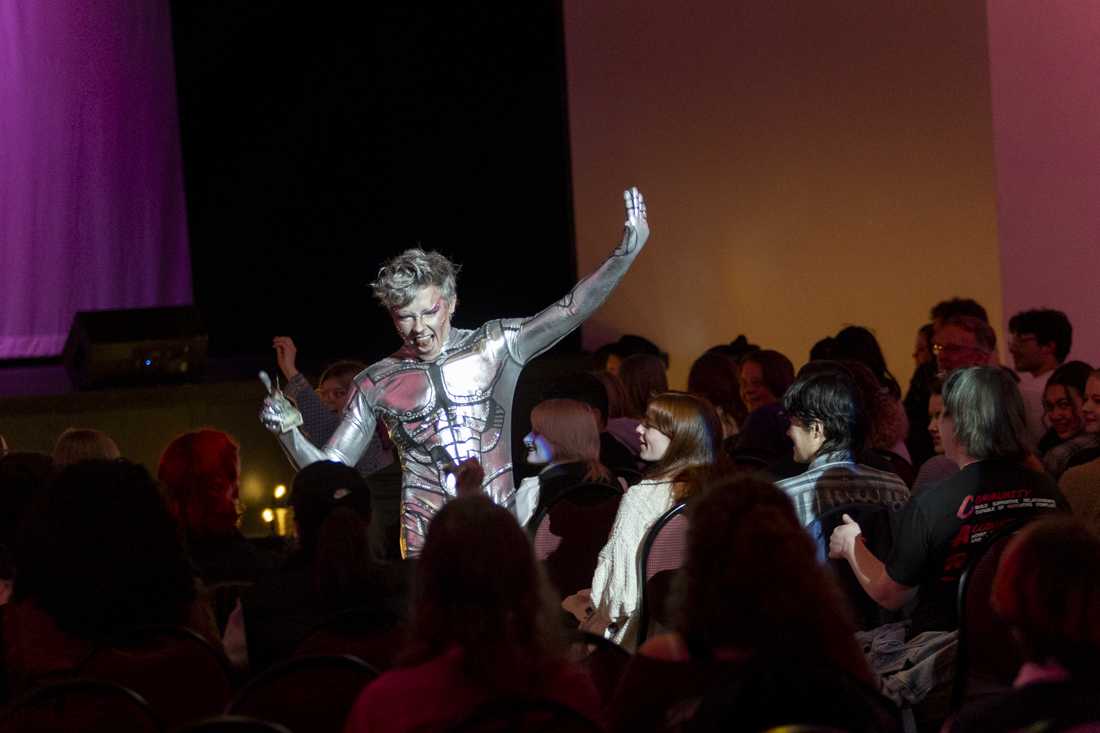 Smash the King, a UO student and drag king, collects tips and walks through the audience during his performance at the UO LGBTQA3 Alliance's annual drag show in the EMU Ballroom on Feb. 17, 2024. (Alex Hernandez/Emerald)