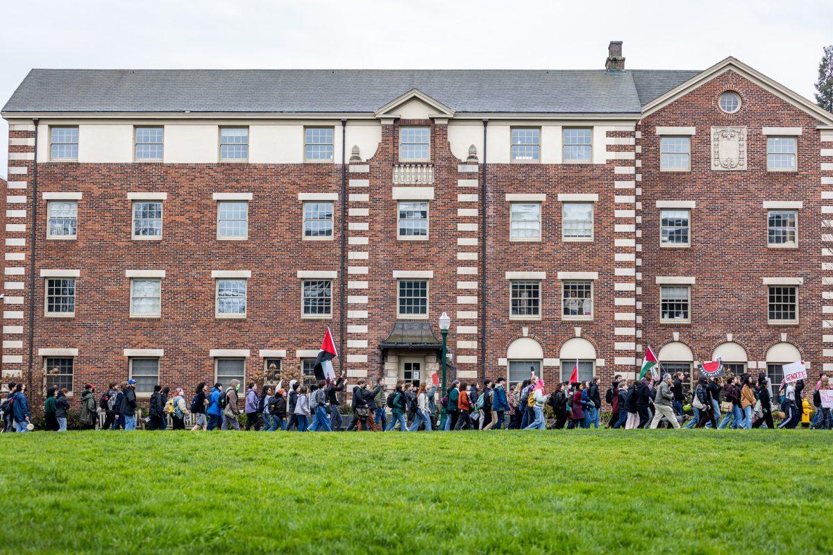 The protestors take laps around the EMU lawn as they chant and urge fellow students to join their cause. (Jonathan Suni/Emerald)