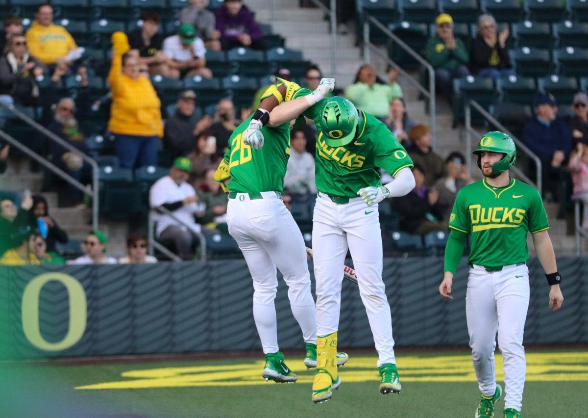 Jacob Walsh (25) celebrates his first Home Run of the season with teammate Mason Neville (26). The Oregon Baseball team defeats Lafayette College 17-3 in Game 1 of the series at PK Park in Eugene, Ore., on Feb.23, 2024. (Alyssa Garcia/Emerald)