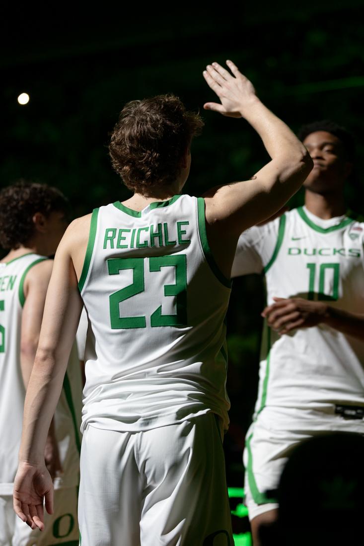 Gabe Reichle (23) high fives Kwame Evans Jr. (10) as the starting lineups are announced. The Oregon Men&#8217;s Basketball team beat Oregon State University 78-71 at Matthew Knight Arena in Eugene, Ore., on Feb. 28, 2024. (Kemper Flood/ Emerald)