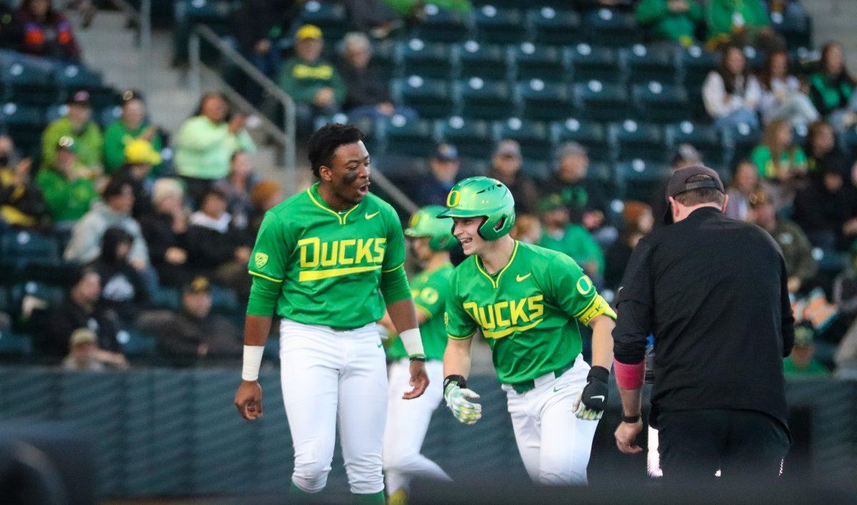 Ryan Cooney (12) celebrating his first career home run with Jeffery Heard (35). The Oregon Baseball team defeats Lafayette College 17-3 in Game 1 of the series at PK Park in Eugene, Ore., on Feb.23, 2024. (Alyssa Garcia/Emerald)