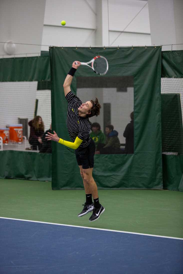 Quinn Vandecasteele serves the ball. Oregon Men's Tennis face off against UC Riverside in Eugene, Oregon on January 20, 2023. (Kai Kanzer/Emerald)