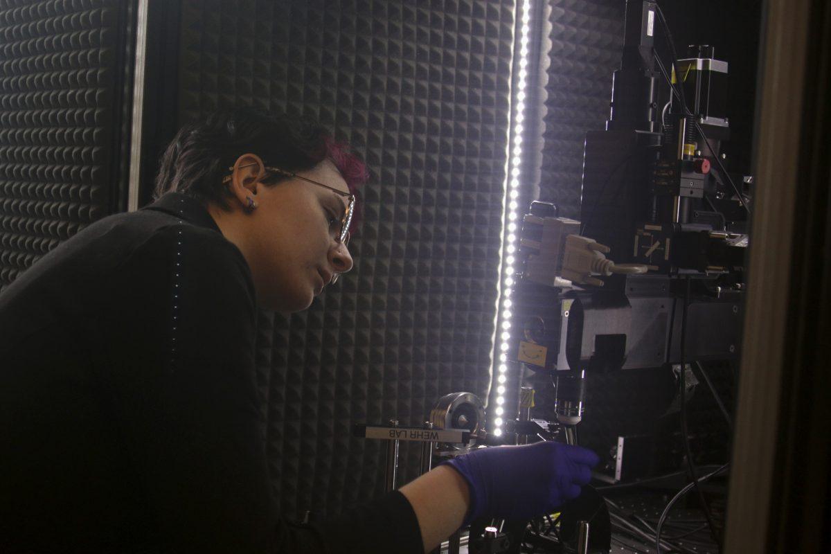 Graduate student Rocky Penick sets up a microscope used for Alzheimer&#8217;s disease research in one of the Lewis Integrative Science Building labs on Jan. 31, 2024. (Colleen Bogdan/Emerald)