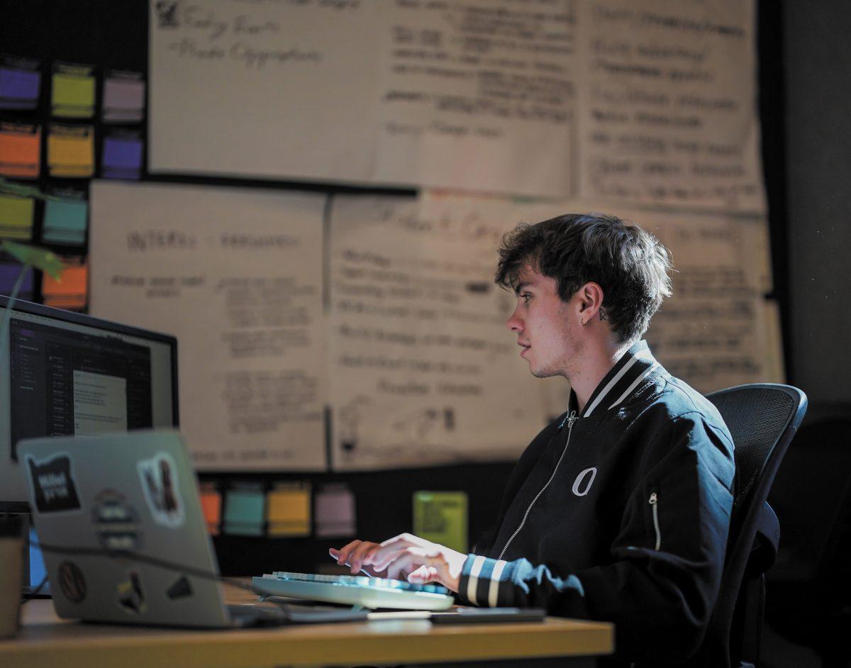 Finn Jacobson working away at his desk in the ASUO suite. Search for Vice President of Student Life, Eugene, on March 14, 2024. (Eddie Bruning/Emerald)