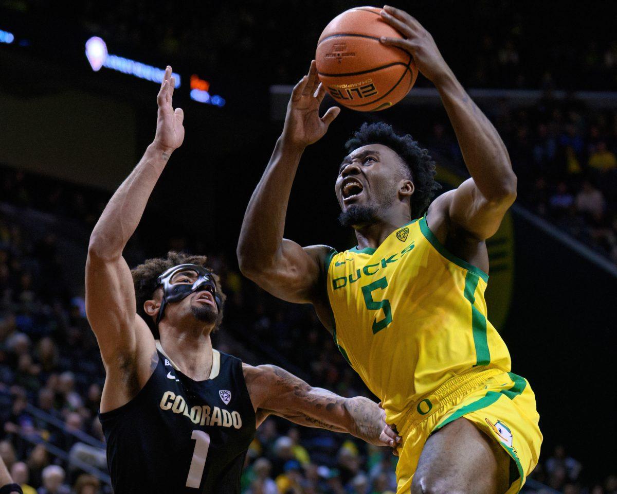 Oregon Guard Jermaine Couisnard #5 (right) pushes towards the basket against Colorado Guard J'Vonne Hadley #1 (left.) The University of Oregon Ducks Men's Basketball team was defeated by the University of Colorado Buffaloes 79-75 in a home game at Matthew Knight Arena in Eugene, Ore., on March 7, 2024. (Eric Becker/Emerald)