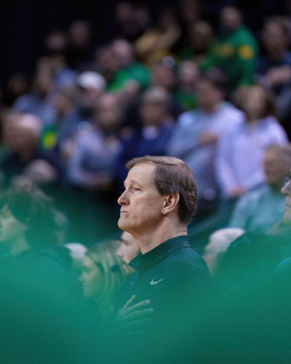 Oregon Head Coach Dana Altman puts his hand over his heart while the national anthem plays before the game. The University of Oregon Ducks Men's Basketball team was defeated by the University of Colorado Buffaloes 79-75 in a home game at Matthew Knight Arena in Eugene, Ore., on March 7, 2024. (Eric Becker/Emerald)