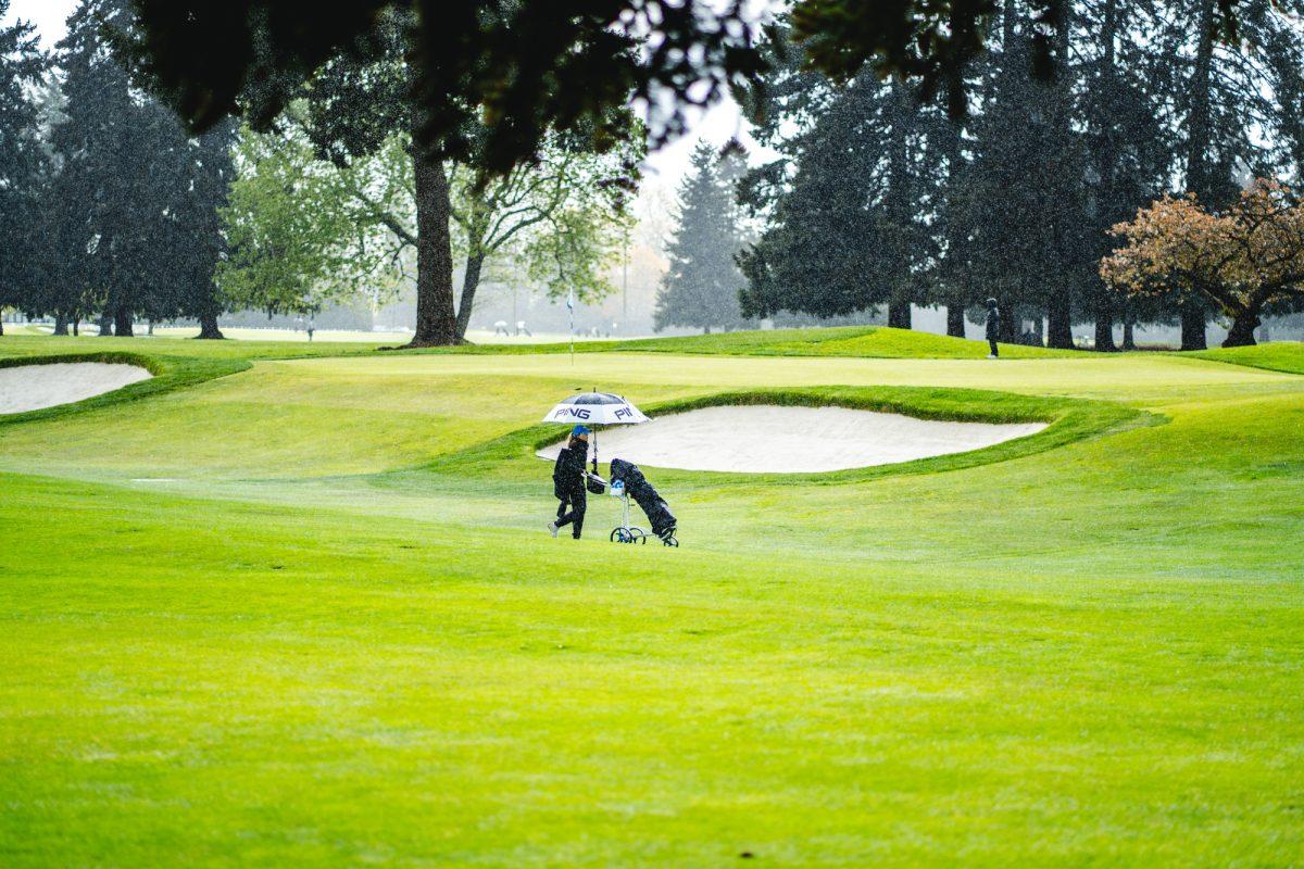 A golfer walks through the rain during the championships.&#160;The Eugene Country Club hosted the Pac-12 women's golf championships from April 18-20, 2022. (Will Geschke/Emerald)