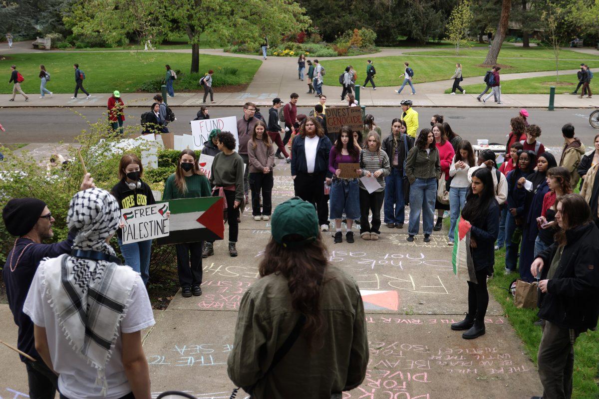 Demonstrators rally at Johnson Hall in support of the SJP&#8217;s sit-in, held outside of UO President Scholz&#8217;s office on April 12, 2024. They call for university divestment from Jasper Ridge and the implementation of a Boycott, Divestment and Sanctions (BDS) campaign on campus, among other demands. (Colleen Bogdan/Emerald)