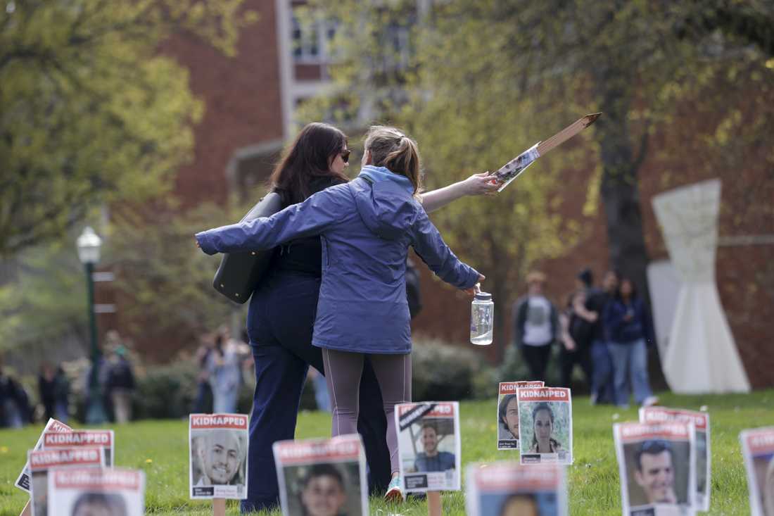 A person walking by attempts to disrupt the demonstration, yelling "Israel is committing genocide," and "Propaganda that centers Israel," while pulling up and damaging the signs that were spread across the lawn outside of the UO Lillis Business Complex on April 8, 2024. (Alex Hernandez/Emerald)