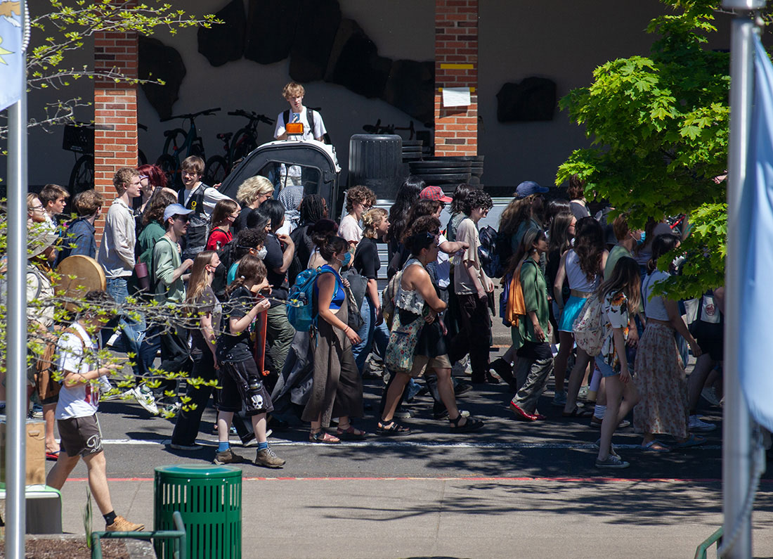 Protesters march on 13th Ave past the Erb Memorial Union. On May 10, 2024, Hundreds of protestors marched through the fair opposing The University of Oregon administration&#8217;s response in negotiations to close the encampment tomorrow. After briefly entering Johnson Hall, the group circled around the Erb Memorial Union before returning to camp. (Miles Cull/Emerald)