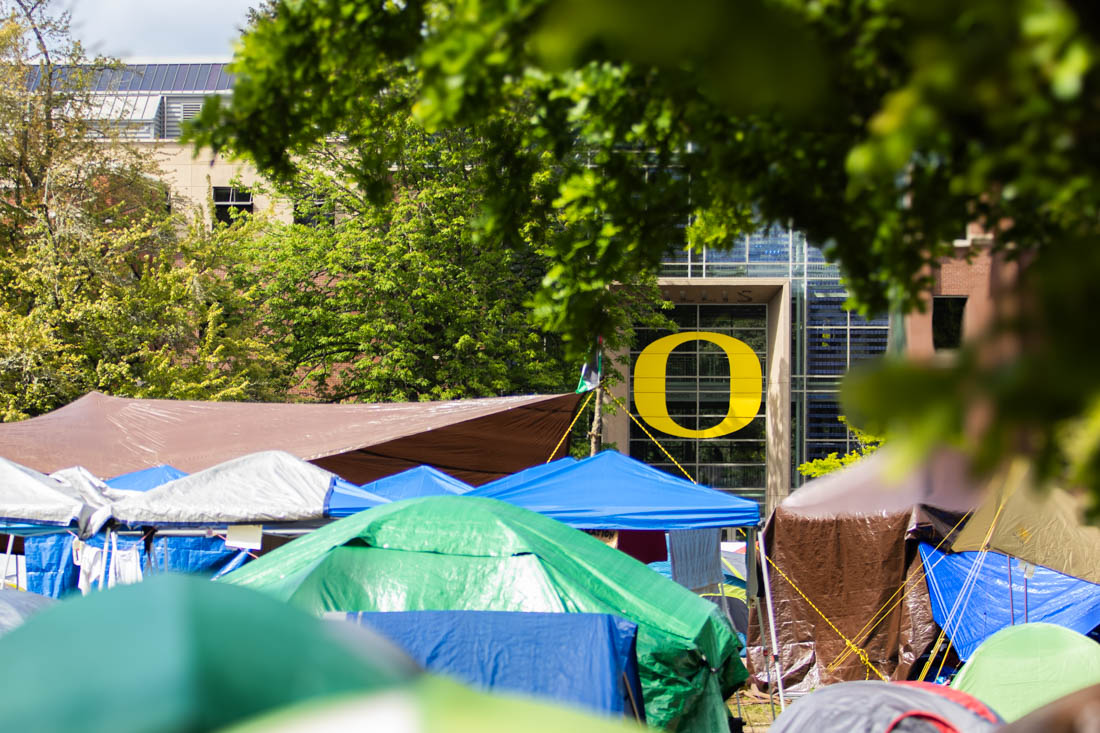 The encampment set against the backdrop of the iconic 'O' at the Lillis Business Complex. Hundreds of protesters gathered at the site of the encampment on campus, the Memorial Quad, and protested in support of Palestine on May 7, 2024. (Mason Cruz/Emerald)