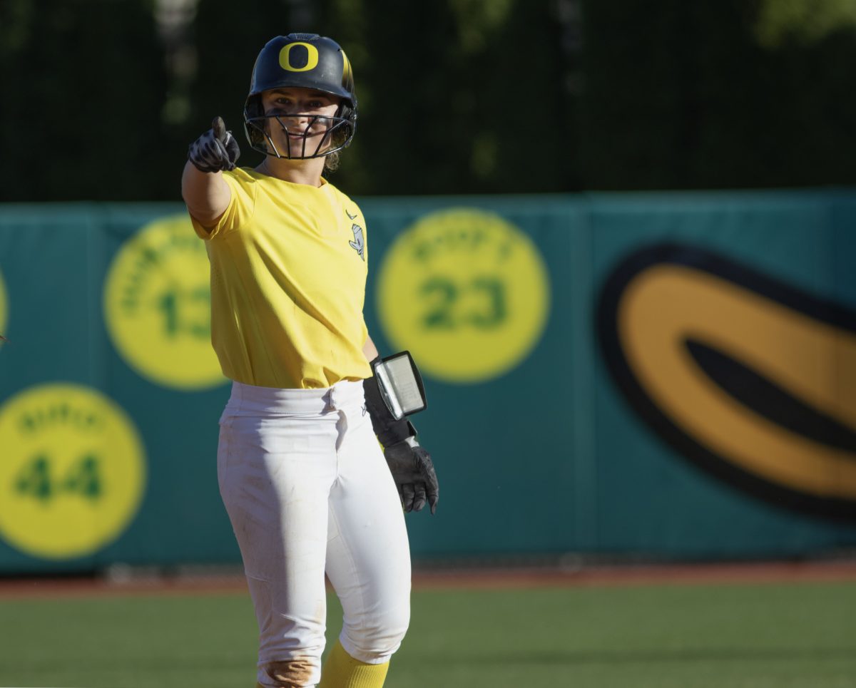 Paige Sinicki (38) points to the Oregon dugout after hitting a double.The Oregon Softball team secures the win 11-3 over Oregon State in game 1 of their Rivalry Series, hosted at Jane Sanders Stadium in Eugene, Ore., on April 19, 2024. (Alyssa Garcia/Emerald)