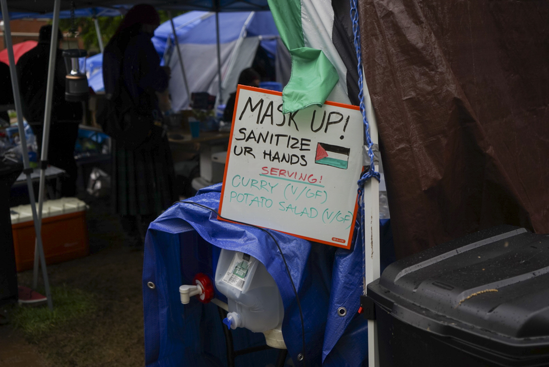 Free meals are served to protesters multiple times throughout the day at the encampment. The encampment has been erected on the lawn between Lillis and the Knight Library at the University of Oregon (Lulu Devoulin/ Emerald)