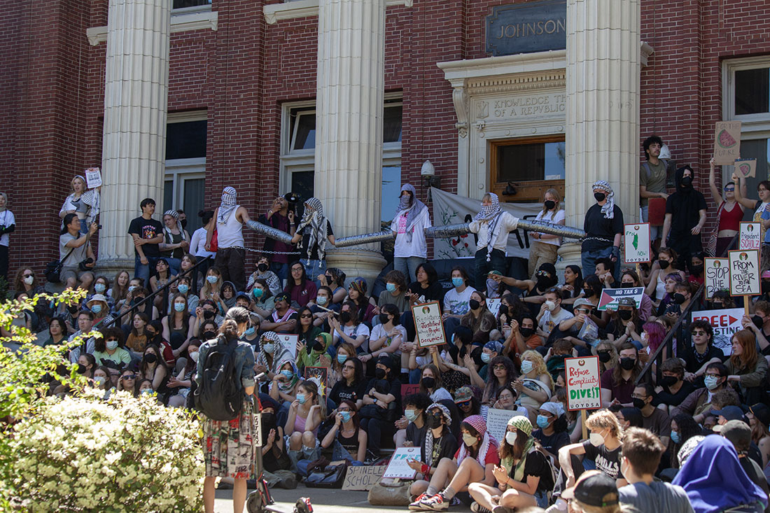 After the mock tribunal of Karl Scholz, Paul Weinhold, and Steve Holwerda. Protesters started a sit in on the steps of Johnson Hall. (Miles Cull/Emerald)