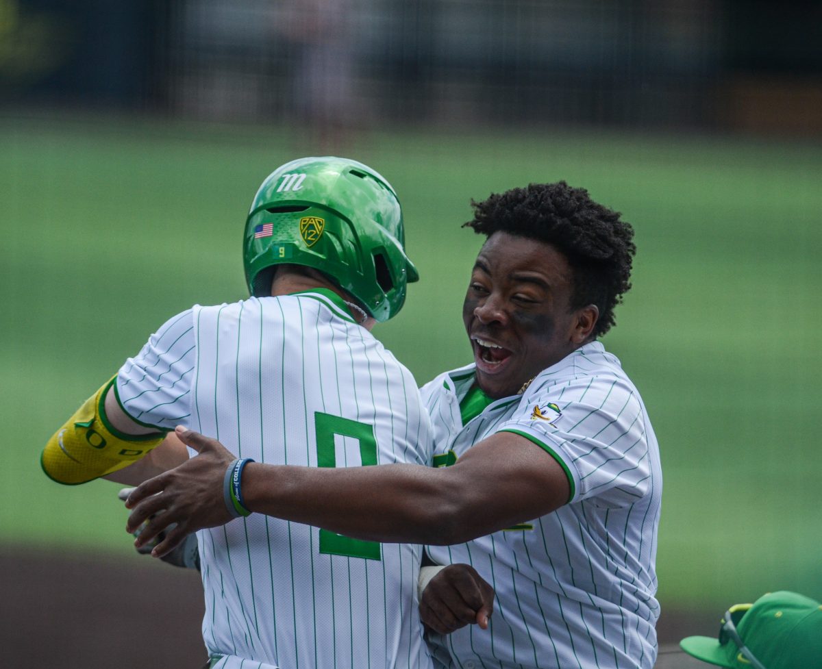 Maddox&#160;Molony (9) celebrates with&#160;Jeffery&#160;Heard (35) after hitting a home run. (Kai Kanzer/Emerald)