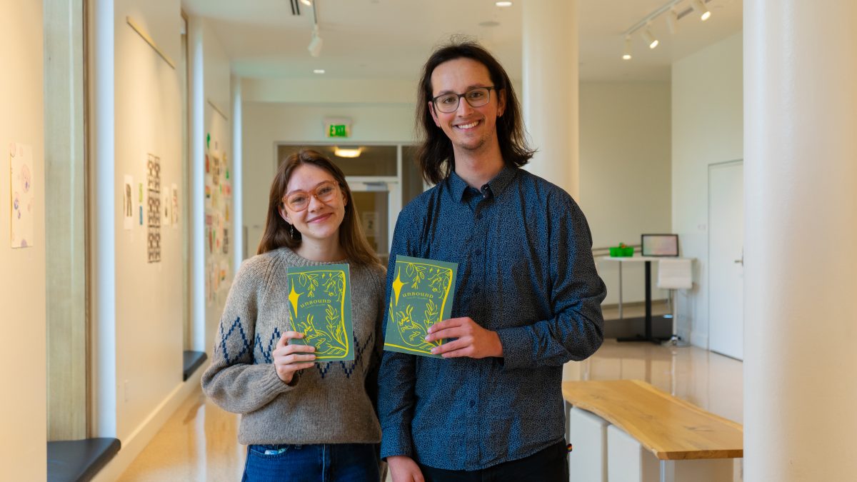 Brynn Lemons and Nathan King, co-editors of the Unbound Literary Journal, hold their recently published journals. (JR Quint/Emerald)