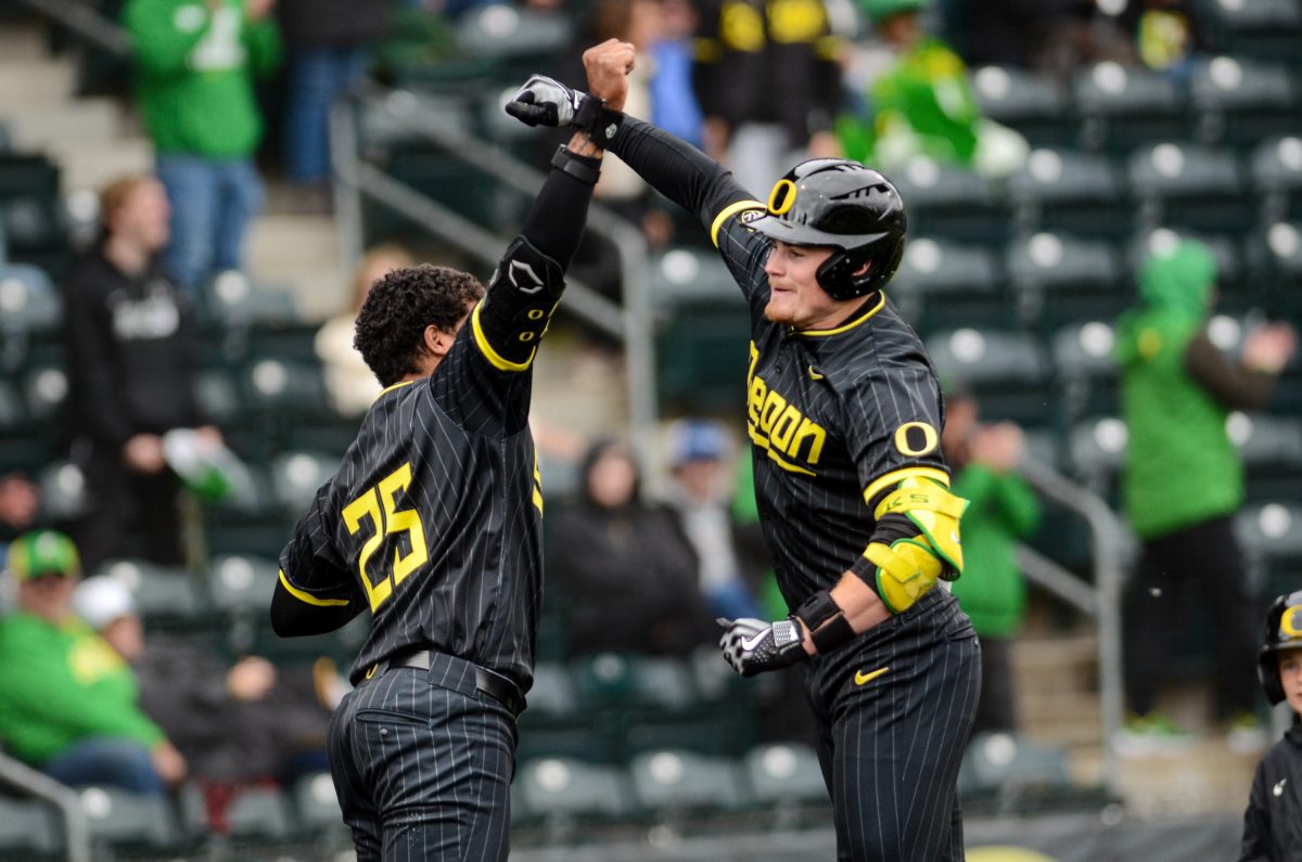 Bryce Boettcher (28) celebrates with Jacob Walsh (25) after hitting back-to-back home runs with Bennett Thompson (16). Boettcher brings the Ducks within one run in the eighth inning.&#160;The Utah Utes Baseball Team avoid the sweep, winning game three of the series 9-7 at PK Park in Eugene, Ore., May 5, 2024. (Kai Kanzer/Emerald)