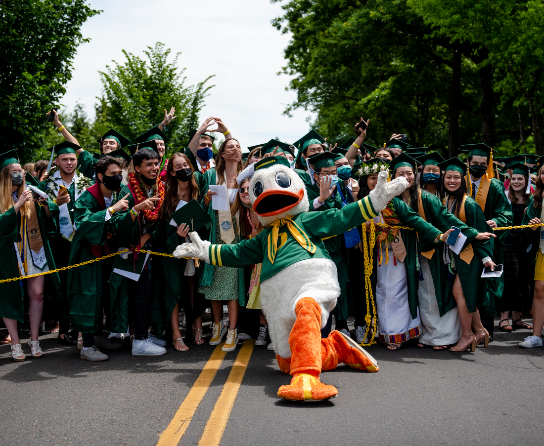 University of Oregon mascot the Duck poses with the crowd of graduates before the beginning of this years Grad Parade. After a full academic year of online school, the class of 2021 participated in the University of Oregon's traditional Grad Parade on June 12, 2021. (Ian Enger/Emerald)