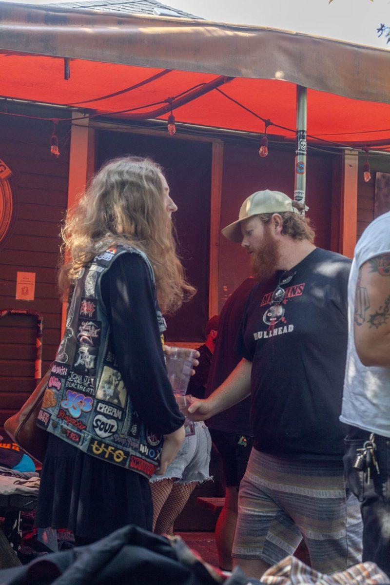 Attendees gather at the punk clothing swap at Sam’s Bonds Garage. The clothing swap encouraged people to bring their clothes to swap out with what they wanted from the tables. Alongside the swap, live music was present inside the bar. (Miles Cull/Emerald)