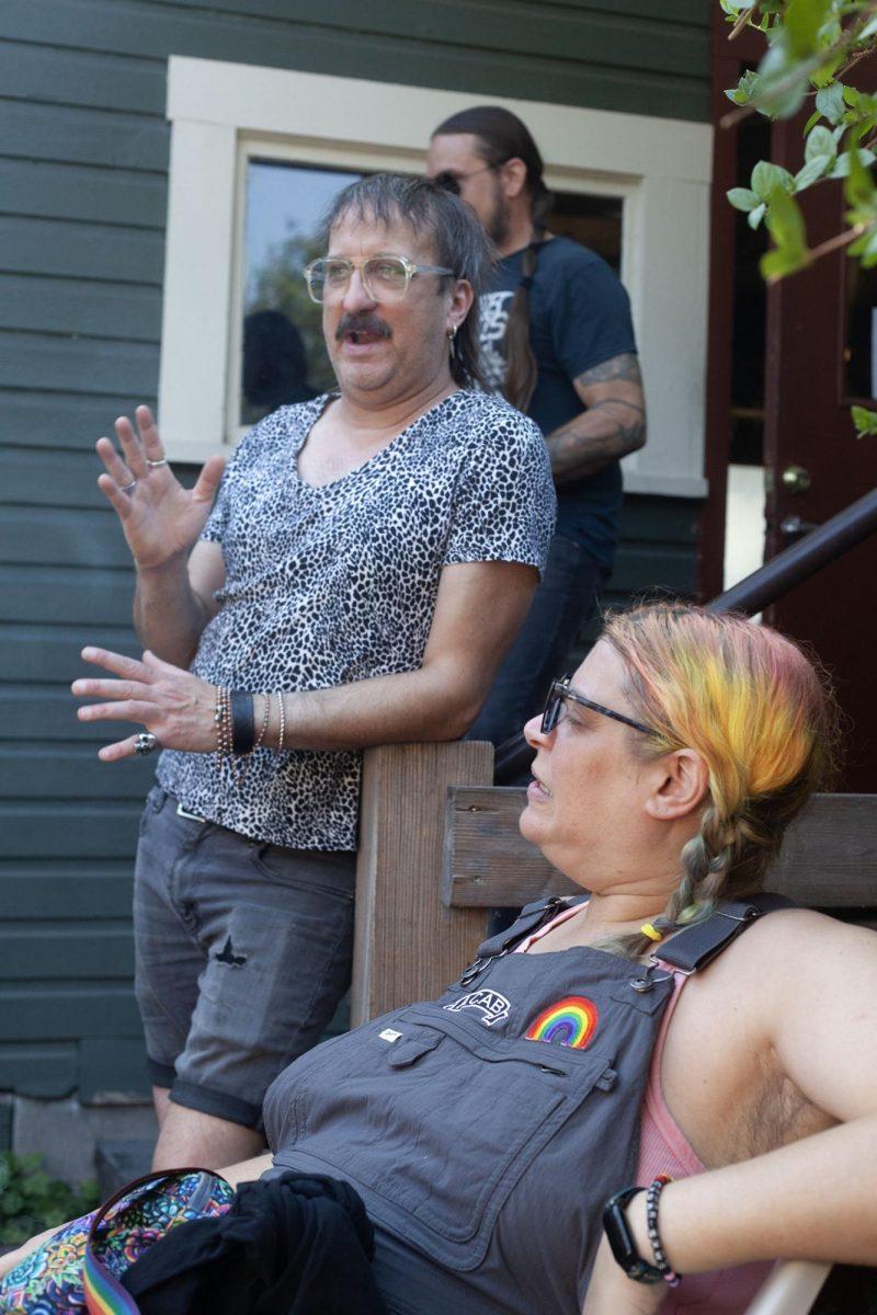 Attendees gather at the punk clothing swap at Sam’s Bonds Garage. The clothing swap encouraged people to bring their clothes to swap out with what they wanted from the tables. Alongside the swap, live music was present inside the bar. (Miles Cull/Emerald)