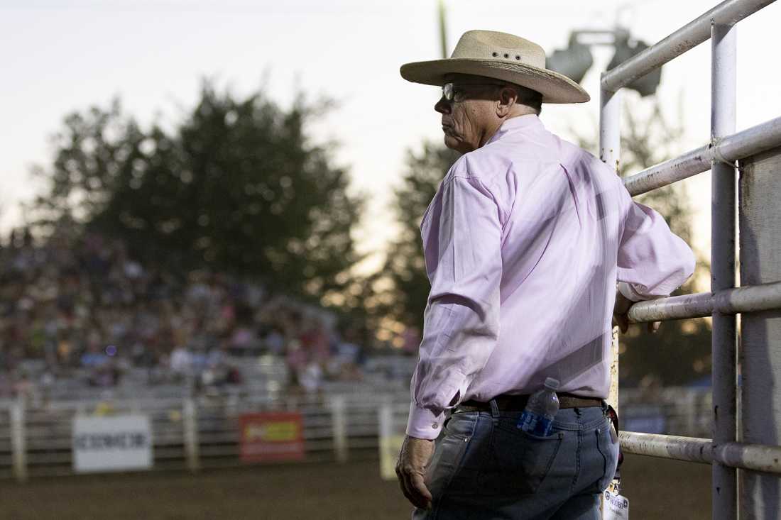 A man holds the gate open between rodeo events on July 3, 2024. The Eugene Pro Rodeo kicked off its first day with the theme of "Tough Enough to Wear Pink," in support of cancer awareness. (Alex Hernandez/Emerald)