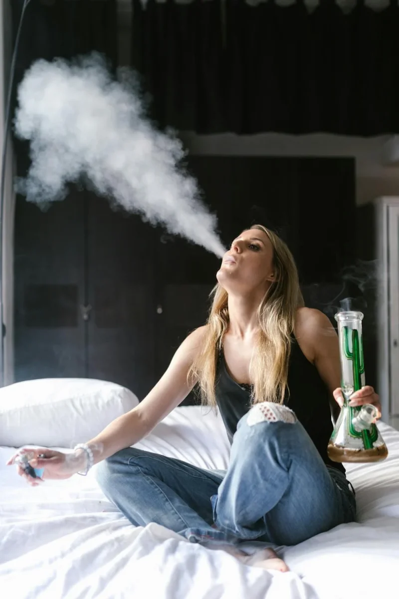 https://www.pexels.com/photo/a-woman-using-a-bong-on-the-bed-8140287/