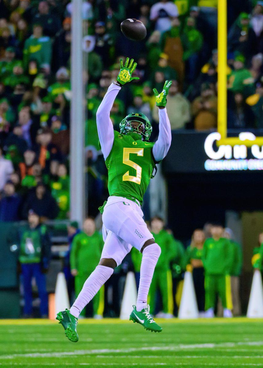 <p>Oregon DB Khyree Jackson (5) attempts to intercept the ball. The University of Oregon Ducks Football team defeated Oregon State University 31-7 in a home match at Autzen Stadium in Eugene, Ore., on Nov. 24, 2023. (Eric Becker/Emerald)</p>