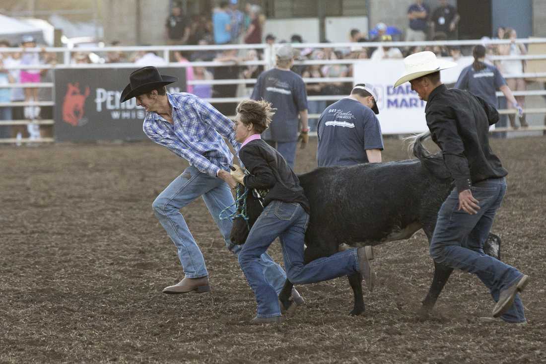 Teams of high schoolers participate in the "Calf Scramble," an event to raise money for various school groups and organizations, on July 3, 2024. The Eugene Pro Rodeo kicked off its first day with the theme of "Tough Enough to Wear Pink," in support of cancer awareness. (Alex Hernandez/Emerald)