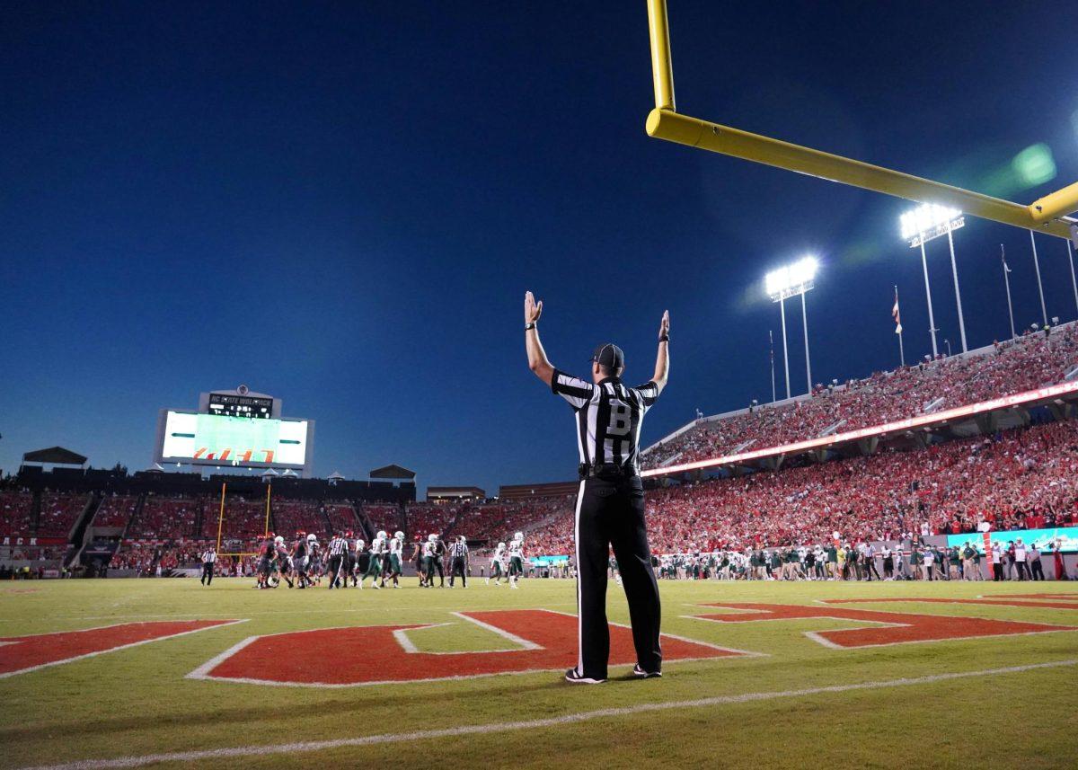 https://unsplash.com/photos/a-football-player-standing-on-a-field-with-his-arms-in-the-air-zZgq0_SqPtU