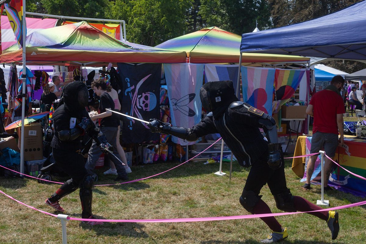 Fencers demonstrate a duel at Eugene Pride in the Park. (Miles Cull/Emerald)