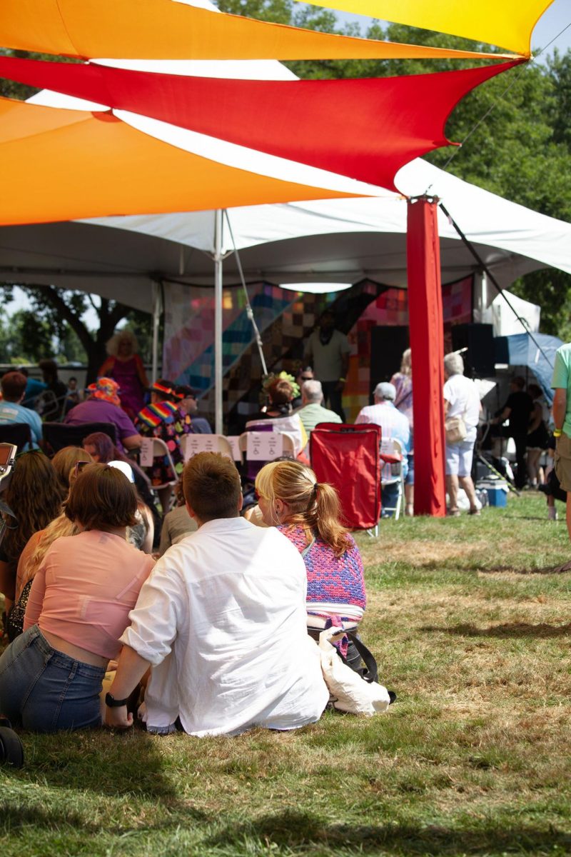 Attendees of Eugene Pride in the Park watch performers on the center stage. (Miles Cull/Emerald)