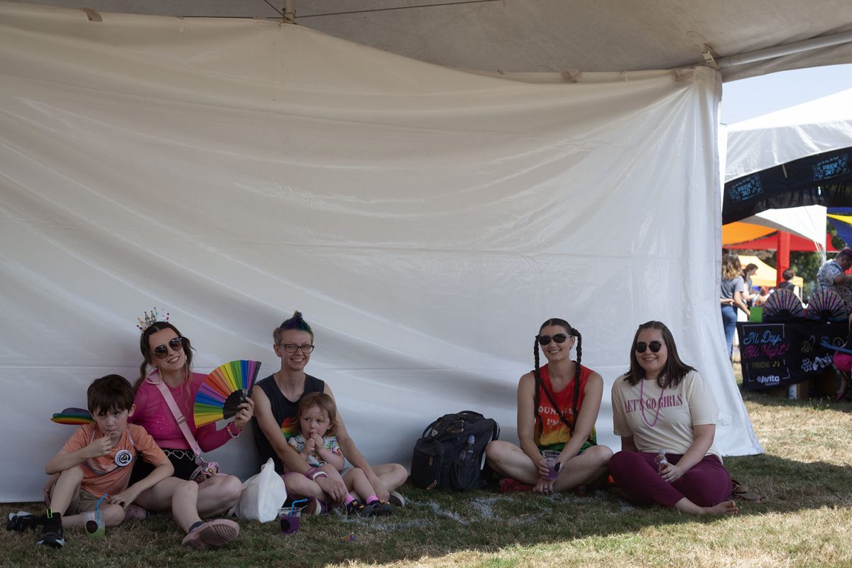 A family takes a moment to rest in the shade. (Miles Cull/Emerald)