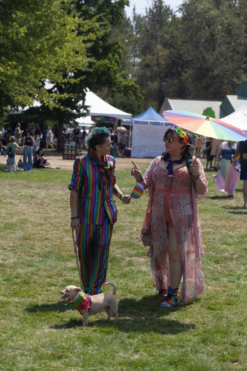 Dressed their best, atendees walk the grounds of Eugene Pride in the Park.(Miles Cull/Emerald)