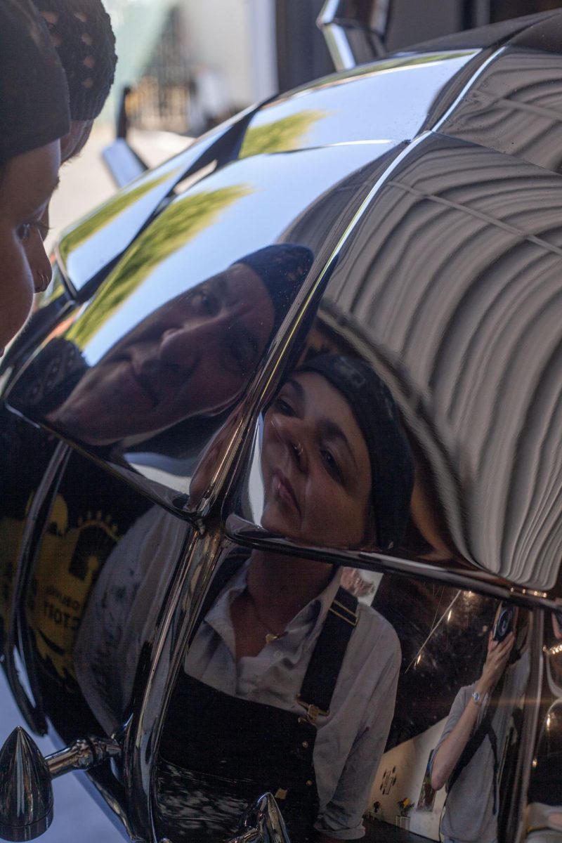 Renee Mahni and Jud Turner peer into a chromed-out crab sculpture in The Oblivion Gallery, unveiled August 3. Turner said that the studio provided him and his wife, Renee Mahni, a place for people to experience their sculptures. They plan to host a guest artist in the gallery the first Saturday of each month. (Miles Cull/Emerald)