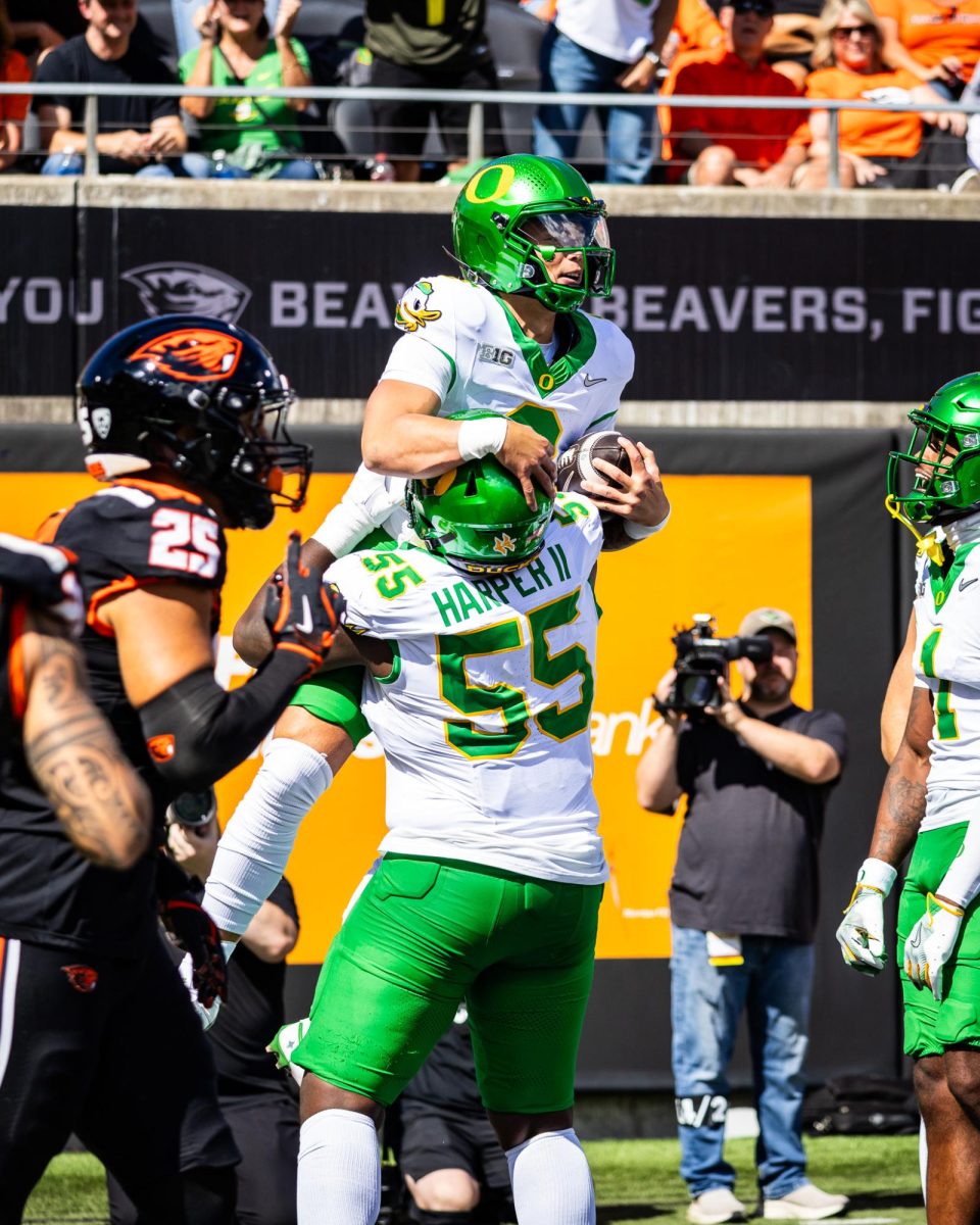 Dillon Gabriel (8) celebrates a massive 54-yard rushing touchdown that electrifies his team along with the Duck fans who are scattered around Reser Stadium. The Oregon Ducks travel up to Corvallis to face their in-state rival the Oregon State Beavers on September 14th, 2024. (Jonathan Suni/Emerald)