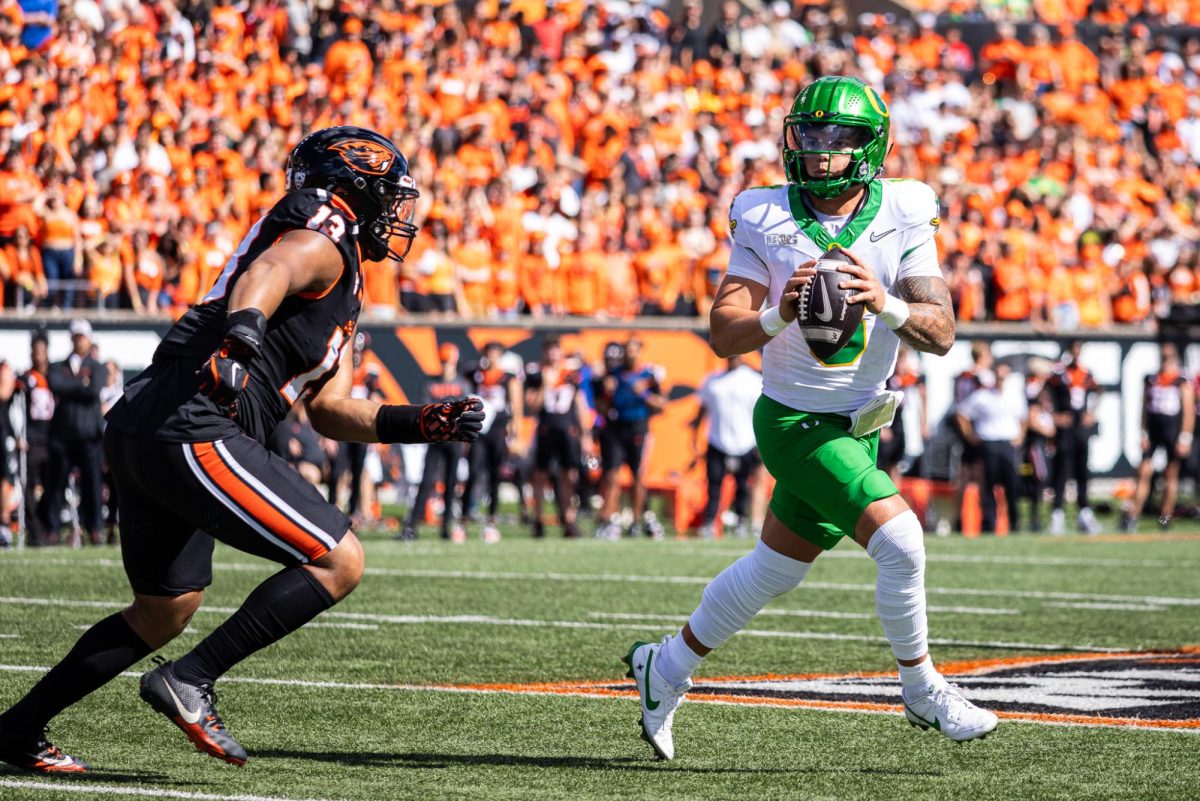 Dillon Gabriel (8) uses his mobility to create some more time to look for an open receiver. The Oregon Ducks travel up to Corvallis to face their in-state rival the Oregon State Beavers on September 14th, 2024. (Jonathan Suni/Emerald)